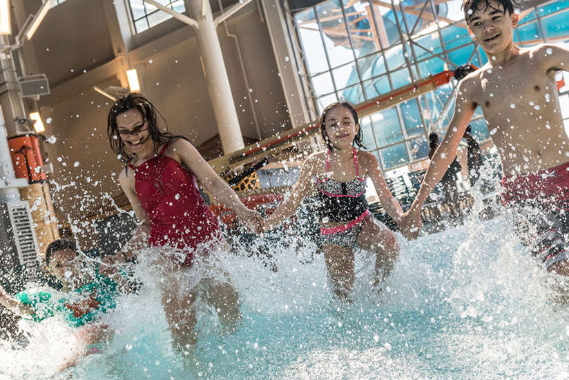 family splashing in the wave pool.