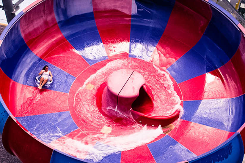 woman swirling around on a water slide