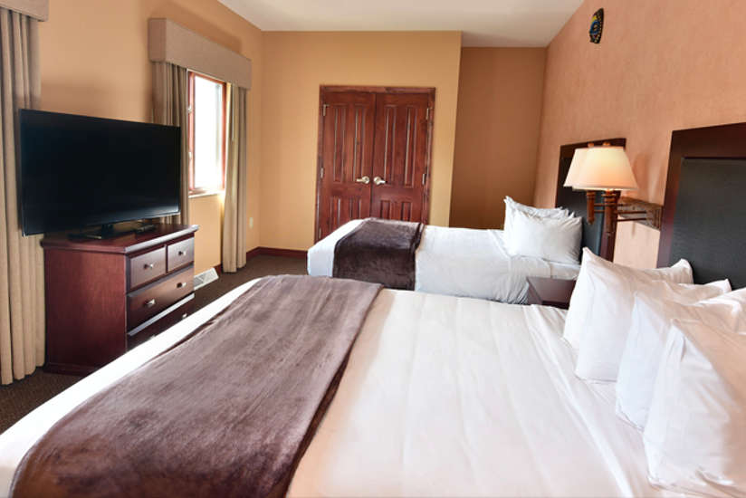 Nyumba Villa large bedroom with two large beds.