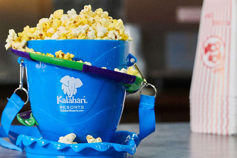 a cool bucket of popcorn that has a waterslide around it