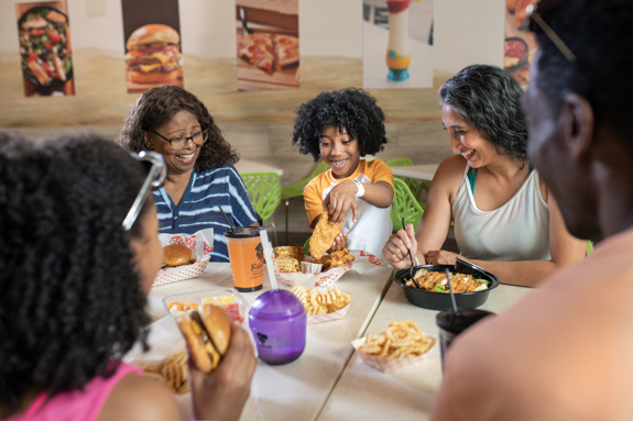 family sitting down for lunch at kukus chicken