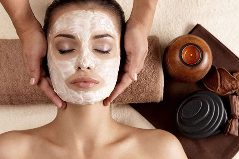 a woman relaxing while getting a facial in the spa