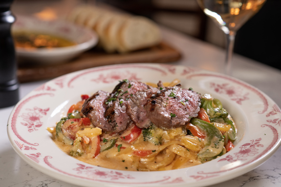 6 ounce filet mignon, olive oil, garlic, scallions, broccoli, Parmesan cream sauce, Calabrian chile, fettuccini pasta