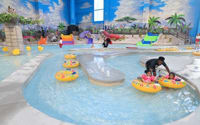 Children riding in the child's lazy river in the Indoor Waterpark