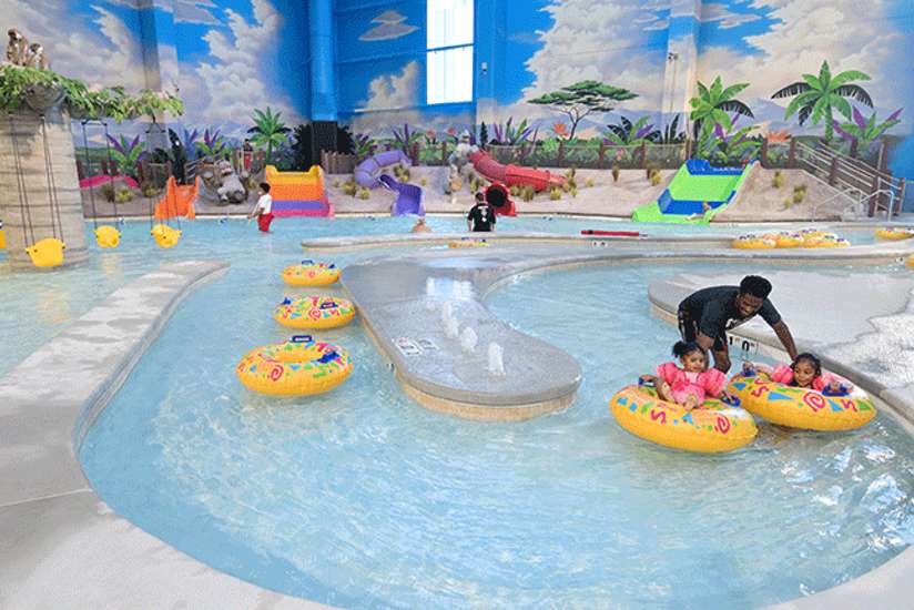 Children riding in the child's lazy river in the Indoor Waterpark