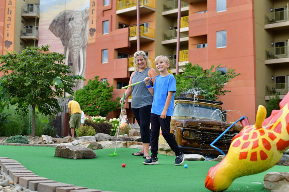Mom and son playing a game of mini golf