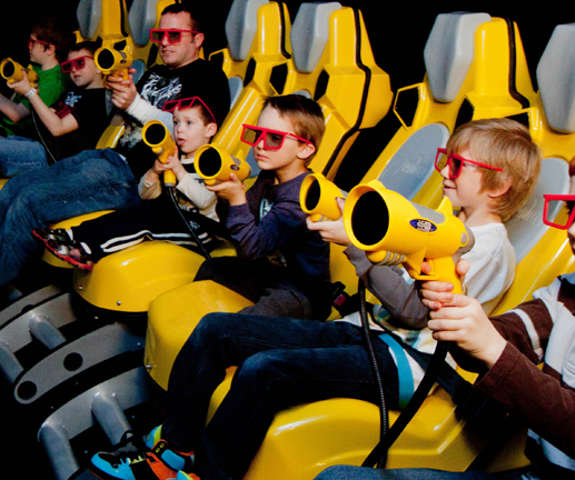 a group of kids playing in the 7-D motion theatre