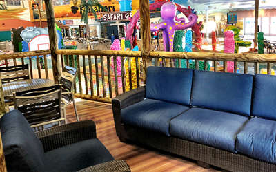 Overview of the leopard cabana. Includes table, chairs, and a couch. It's right by the kiddie area