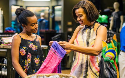 a mother and daughter taking a closer look at a garment as they shop in one of Kalahari's stores