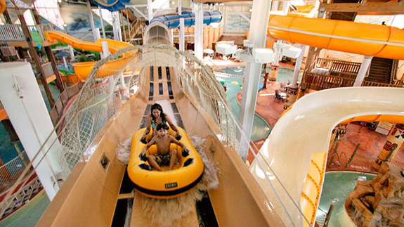 a mother and her son enjoying a water slide