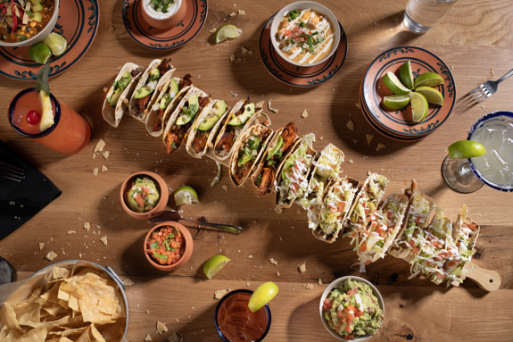 Taco Party Platter with a table full of chips and dips