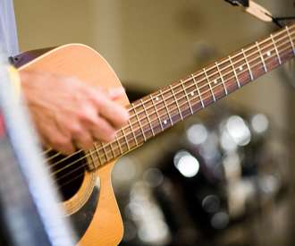 person strumming guitar