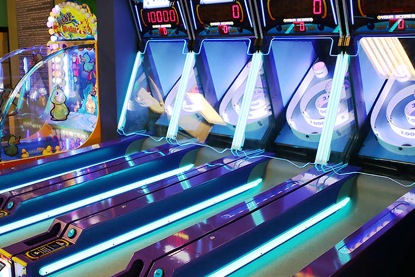 Four skeeball games with cool neon lighting.