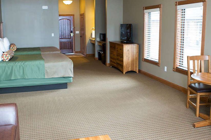 an overview of the Cabin's bedroom with two beds and couch