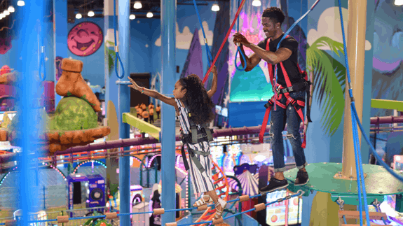 Father and young daughter navigating the Tarantok Rise Attraction.