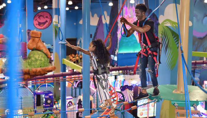 Father and young daughter navigating the Tarantok Rise Attraction.