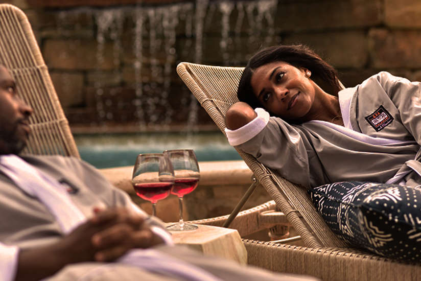 Couple in robes enjoying wine on the outdoor patio